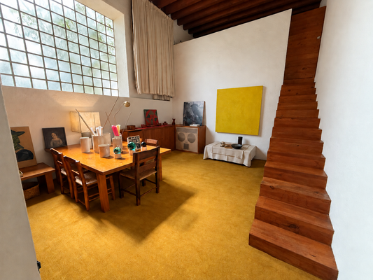 Luis Barragán — interior with wooden staircase and continuous yellow carpet