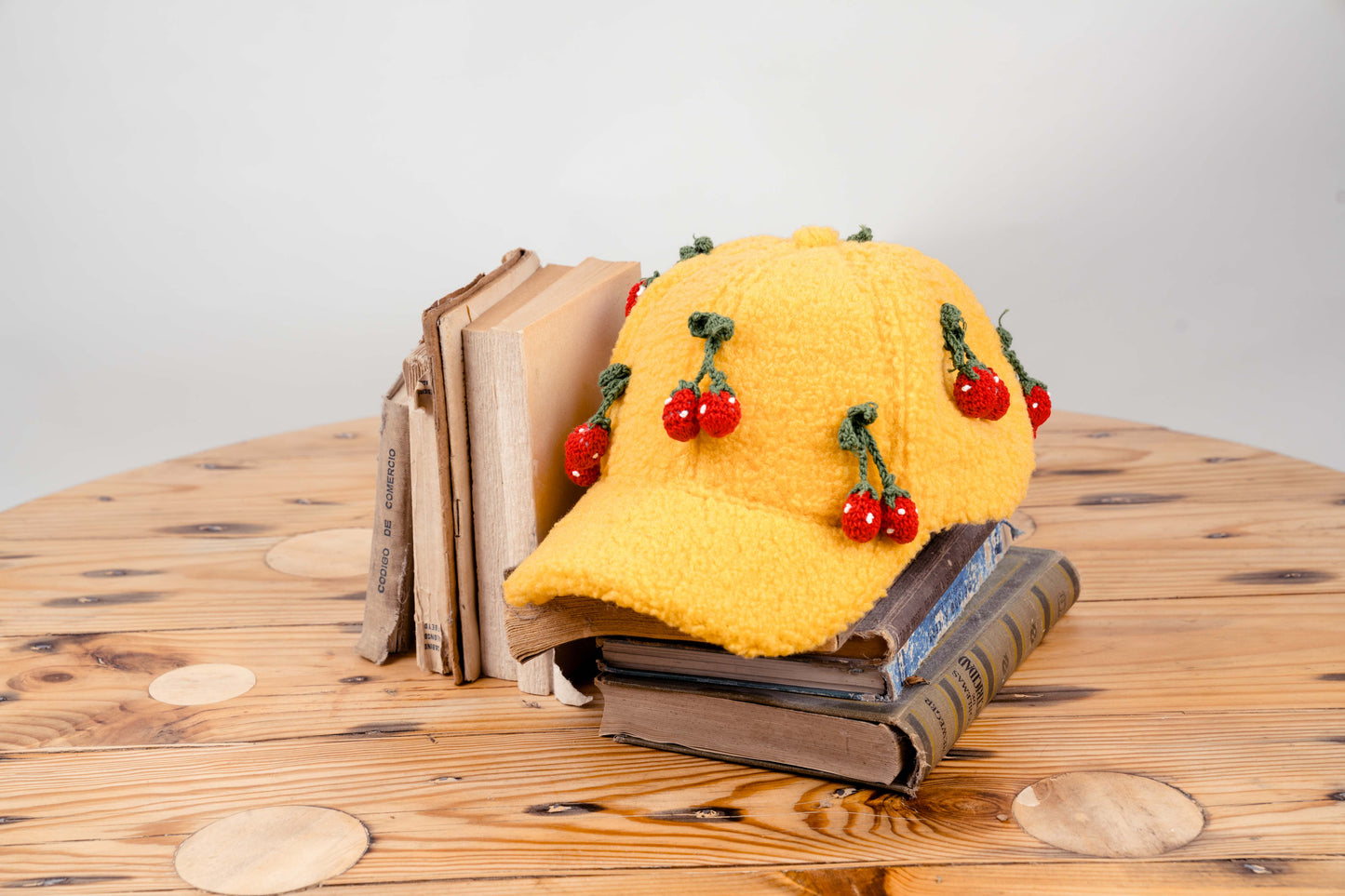 Handcrafted Yellow Wool Cap with Crocheted Cherry Accents