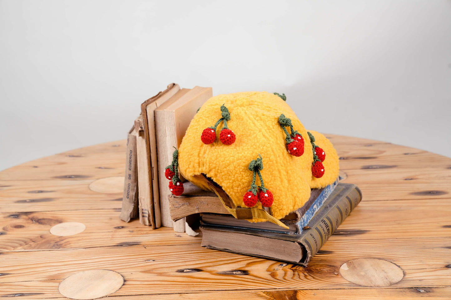 Handcrafted Yellow Wool Cap with Crocheted Cherry Accents